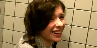 Two dicks are getting put inside a tiny woman in a public restroom