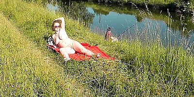Wild Beach. Sexy Milf Platinum Naked Sunbathing On River Bank, Random Fisherman Guy Watches. Naked In Public. Nude Beach