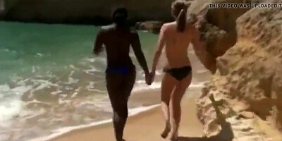 Girls practice interracial threesome on the beach