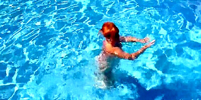 Busty Mature Redhead Melanie Goes For A Swim In The Pool
