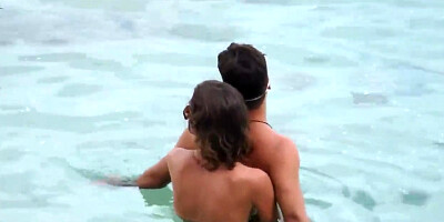 Nude babe caught jerking her BF's cock on the beach