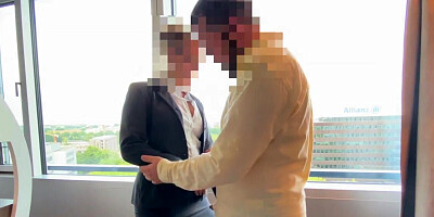 Boss bangs secretary in front of the window