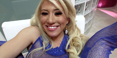 A blonde that has a lovely smile is sucking a big pecker