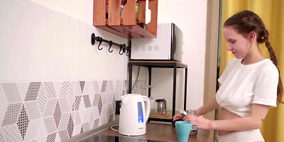 Russian cutie with natural tits masturbates in the kitchen
