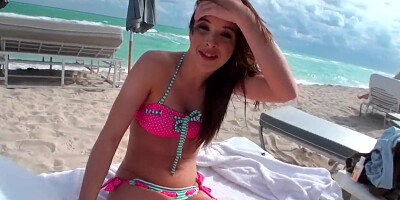 Beautiful and sexy dark-haired minx rests on the beach