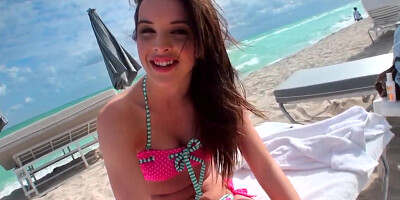 Beautiful and sexy dark-haired minx rests on the beach