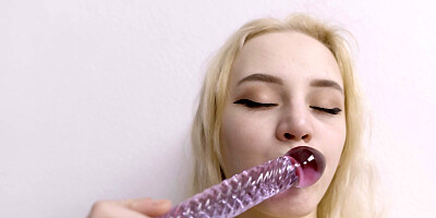 Mia Parker gets naked in the bedroom and plays with a glass dildo