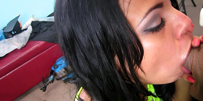 A Latina with an infectious smile is sucking a very large pole