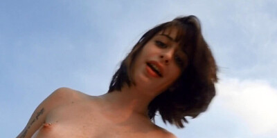 Outdoor intimacy between young lovers on an empty beach