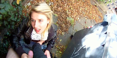 Adorable teenage girl sucking a dick in public