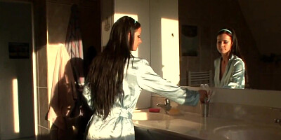 Chick misuses electric toothbrush in the bathroom