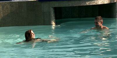 A hot brunette plays with her man in the pool and in the bedroom