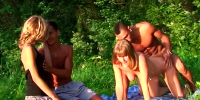 Chicks are getting naked and are fucking with some guys in the woods