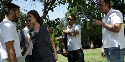 A tiny babe is gangbanged by several men outside on the grass