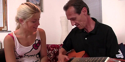 Skinny blonde woman is giving a BJ to an older man