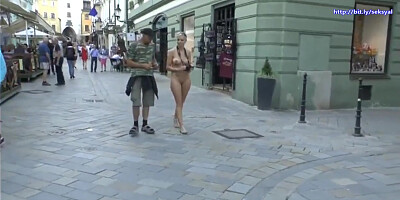 Female tourist walk around the city being naked