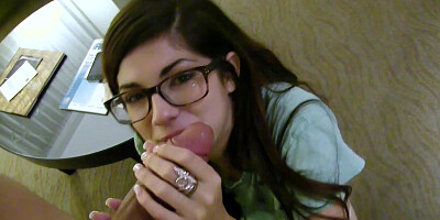 Hottie with large glasses is giving a blow job to her man