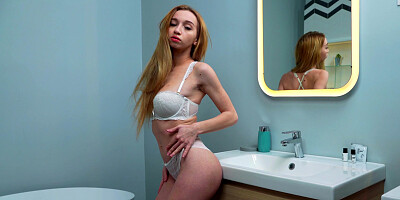 Busty young Leyla Fiore enjoys her body in the bathroom