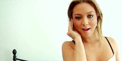 A slender lady with a sexy smile is posing on the bed, naked