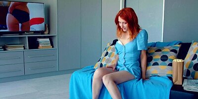 Redhead watches porn and fools around alone