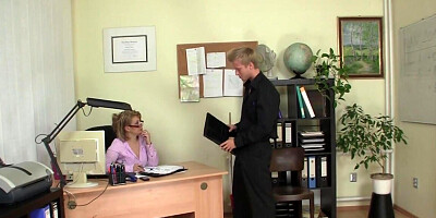 The mature secretary is giving a blowjob to the young stud