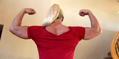 Bulky, German blond is posing in a crimson sundress, while no one else is at home