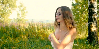 Cute girl wearing glasses for the nudistic picnic