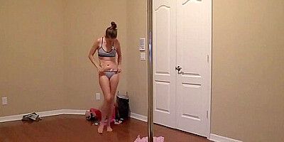 Amateur girl poledancing while she changes in and out of outfits