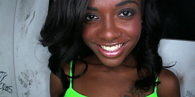 Black chick is teasing a large dick in a glory hole and she smiles