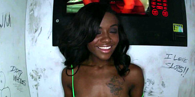 Black chick is teasing a large dick in a glory hole and she smiles