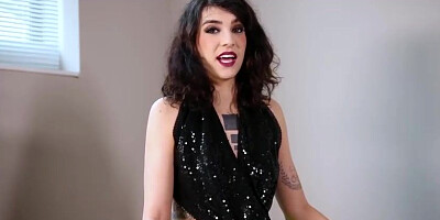 Slender dark haired is posing and taunting in front of the camera, in the middle of the day