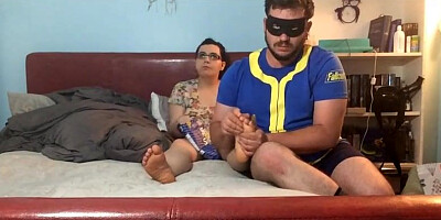 Round school lady is seeing TV while her roomie is nuzzling and munching her toes