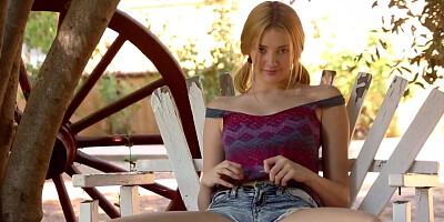 Girl with red hair smiles and masturbates outside