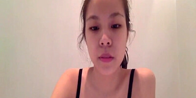 Asian licking a dildo before jamming it deep in her pussy