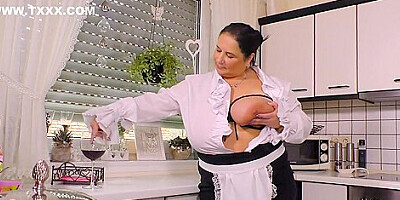 Fat mature with big tits and perky nipples is masturbating in the kitchen and moaning while cumming