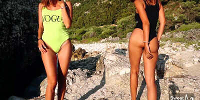 2 slender dolls are about to commence petting heir cunts, while alone on the beach