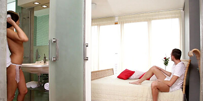 A babe is on her side on the bed and she is getting spooned