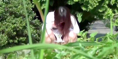 Asian chick pees outdoors in rain