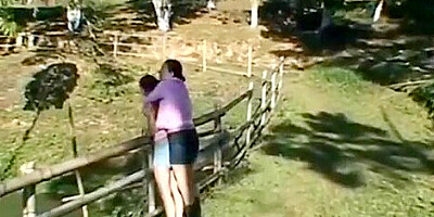 Two brazilian babes kissing outside.