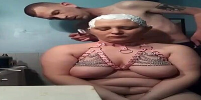 Lush female with monstrous globes is getting her head shaven in front of the camera