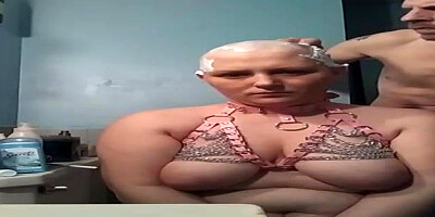 Lush female with monstrous globes is getting her head shaven in front of the camera