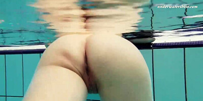 Smallish breasted, Russian dark haired loves to get bare in the swimming pool and knead herself