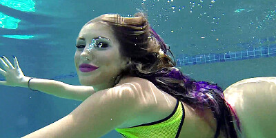 August Ames frolics in a swimming pool with her huge curves