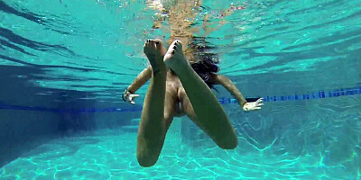 August Ames frolics in a swimming pool with her huge curves