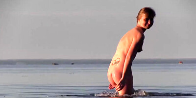 Slender teenage loves to be bare on the beach in the middle of the day