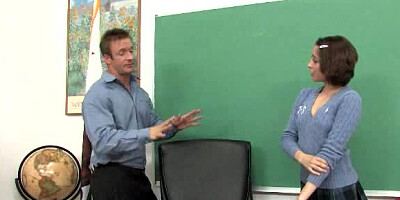 A small cutie with short hair is rammed on the desk by a dude