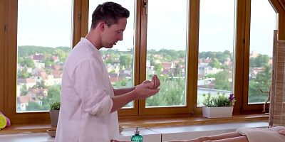 Oiled woman turns the masseur on using feet and enjoys sex