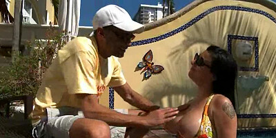 Large breasts are getting handled by the guy by the pool outside