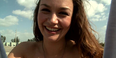 Brunette is naked on the roof, spreading her pussy lips to a guy