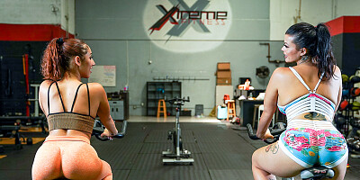 Two dirty babes and a horny stud fucking in the gym